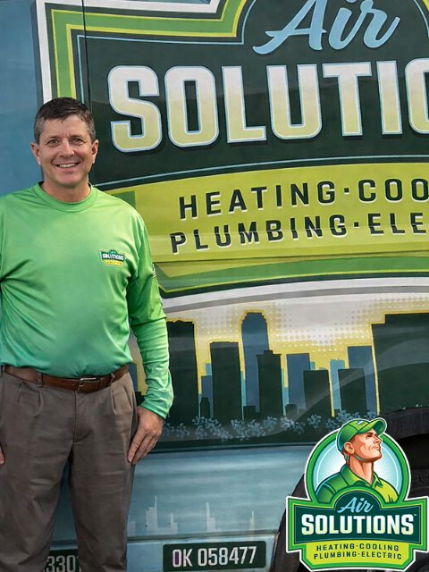 Air Solutions team member standing in front of the company's wrapped truck in Sand Springs, Oklahoma